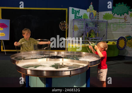 William and Drew Clark blow bubbles at Sci-Quest, Huntsville, Alabama Stock Photo