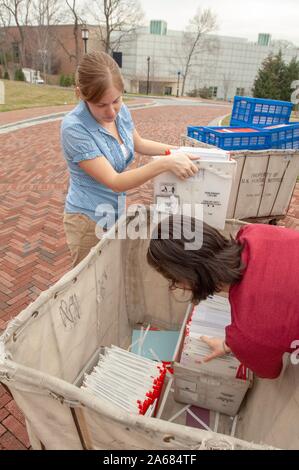 Admissions staff members prepare large mail crates containing acceptance letters and admissions packets on the Homewood Campus of the Johns Hopkins University in Baltimore, Maryland, March 28, 2008. From the Homewood Photography collection. () Stock Photo