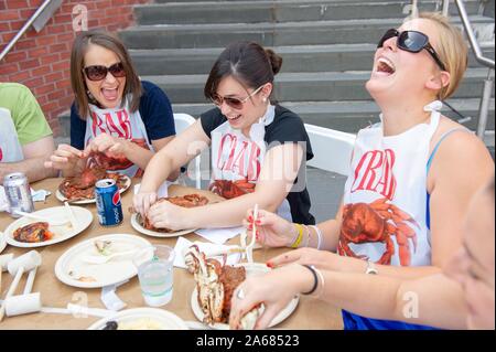 Students participate in a crab feast with the traditional Maryland dish of blue crabs, on the Homewood Campus of the Johns Hopkins University in Baltimore, Maryland, May 21, 2010. From the Homewood Photography collection. () Stock Photo