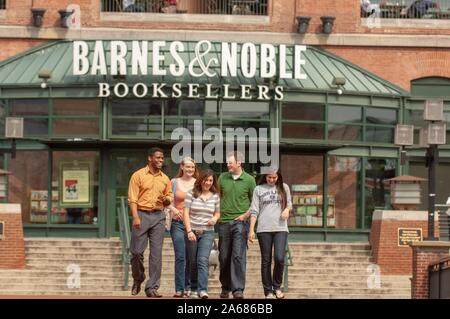 A group of Johns Hopkins University students walk down steps outside the glass-fronted entrance to a Barnes and Noble book store in the former Pratt Street Power Plant, Inner Harbor area, Baltimore, Maryland, May, 2008. From the Homewood Photography Collection. () Stock Photo