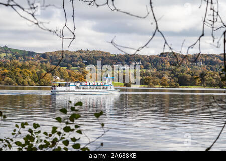 A passenger craft takes tourists along Lake Windermere seen during October 2019 in Cumbria. Stock Photo