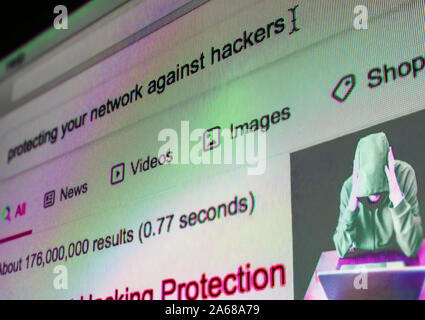 Close-up on the screen, search topic: "protecting your network against hackers". Stock Photo