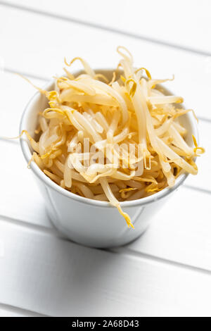 Preserved mung sprout in bowl on white table. Stock Photo