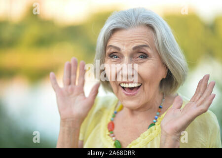 Close up portrait of smiling surprised senior beautiful woman posing Stock Photo