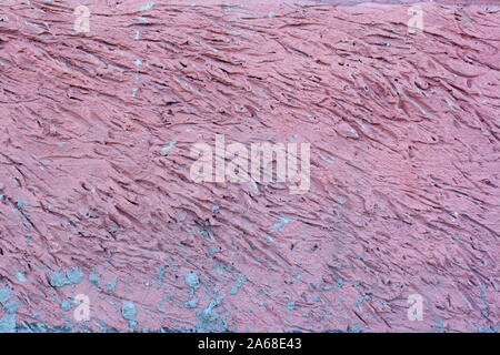 A chaotic striped pattern with recesses in the mortar. It is covered with pink paint. Stock Photo
