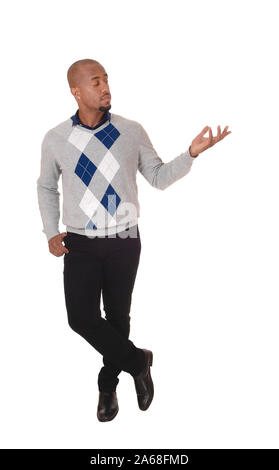 A full body image of an African American man standing in a sweater and black pants, holding his hand out, isolated for white background Stock Photo