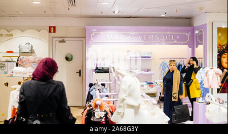 Barcelona, Spain - Nov 17, 2017: Female tourists customers shopping for Young Versace in upscale fashion clothes store in El Corte Ingles mall Stock Photo