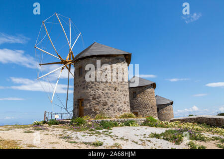 Three restored stone,windmills on top of a hill. These are on the Geeek island of Patmos in the town of Chora. Stock Photo