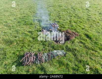 Sequential series of building and lighting survival fire or camp fire. Emergency fire, prepping, survival skills. See additional explanatory NOTES. Stock Photo