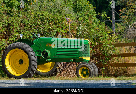 A side view of an antique Oliver farm tractor parked for people to view along a road in British Columbia Canada. Stock Photo