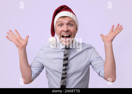 funny male manager in christmas hat is excited and happy Stock Photo
