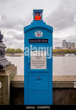 Vintage Police telephone box no longer in use, Victoria Embankment alongside the River Thames, London, UK. Stock Photo