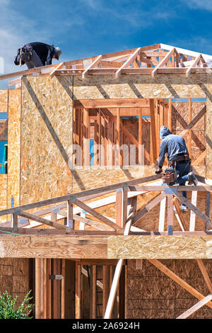 Construction workers building a two story residential house Stock Photo