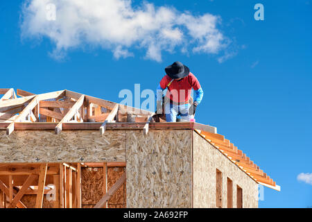 Construction worker building a two story residential house Stock Photo