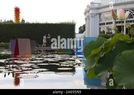 The Bronx, New York / USA - August 13, 2017: Caucasion couple hanging out together in front of the Enid A. Haupt Conservatory Stock Photo