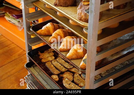 Boothbay Harbor, ME / USA - October 20, 2019: Delicious rolls and various breads in a sheet pan rack Stock Photo