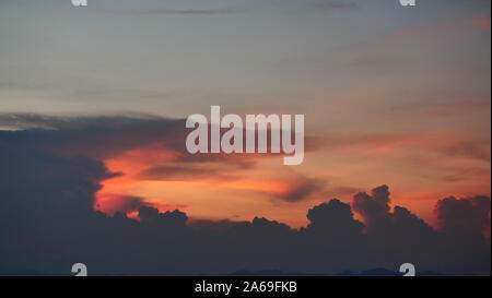 Clouds on tropical blue sky at sunset, The horizon began to turn orange with purple and pink cloud at night, Dramatic cloudscape Stock Photo