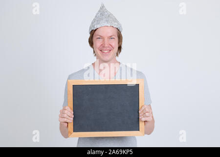 Happy young man with tin foil hat holding blackboard Stock Photo