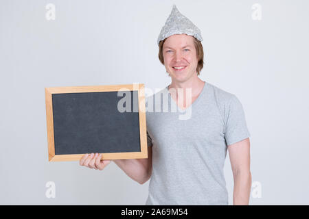 Happy young man with tin foil hat holding blackboard Stock Photo