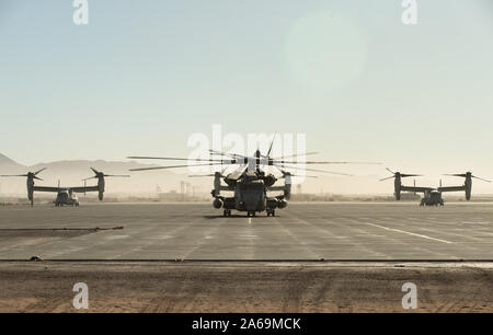 A U.S. Marine Corps CH-53E Super Stallion, center, with Marine Medium Tiltrotor Squadron (VMM) 266, 2nd Marine Aircraft Wing (MAW) taxis before takeoff from the Strategic Expeditionary Landing Field at Marine Corps Air Ground Combat Center, Twentynine Palms, California, Oct. 23, 2019. VMM-266 will be supporting the 2nd Marine Division (2d MARDIV) in the execution of MAGTF Warfighting Exercise (MWX) 1-20. MWX is set to be the largest exercise conducted by the 2d MARDIV in several decades. (U.S. Marine Corps photo by Pfc. Patrick King) Stock Photo