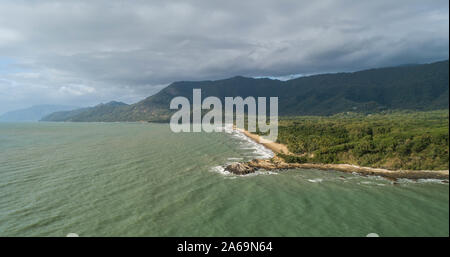 Beautiful tropical landscape with foggy mountains in the background and ocean, beach and headland. Cape tribulation in Australia, Queensland Stock Photo