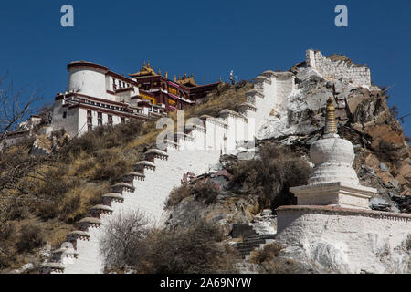Small Buddhist stupa or chorten below the Half Moon Tower on the southwest corner of the Potala Palace in Lhasa, Tibet, a UNESCO World Heritage Site. Stock Photo