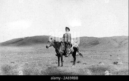 Man on horse; dead antelope carried on horse's back Stock Photo