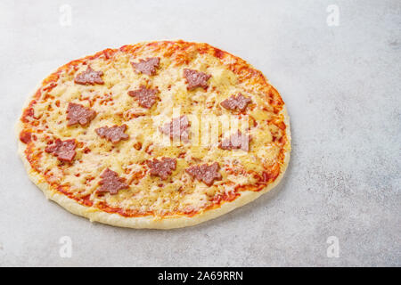Pepperoni pizza decorated with fir-trees for a Christmas dinner. Food delivery concept. Stock Photo