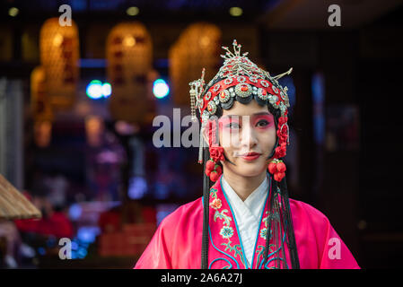 Chengdu, Sichuan Province, China - Oct 11, 2019 : Portrait of a yound woman dressed in Sichuan Opera traditional costume in Jinli street touristic area. Stock Photo