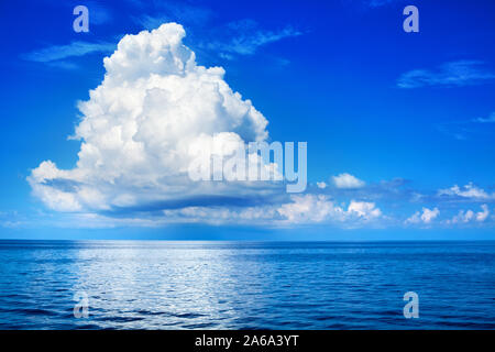 White cumulus clouds in blue sky over sea landscape, big cloud above ocean water panorama, beautiful tropical seascape, cloudy weather, cloudscape Stock Photo