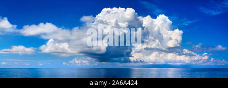White cumulus clouds in blue sky over sea landscape, big cloud above ocean water panorama, beautiful tropical seascape, cloudy weather, cloudscape Stock Photo