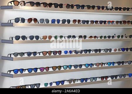 A lot of sunglasses on the wall showcase. Stock Photo
