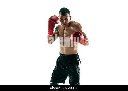 Full length portrait of muscular sportsman with prosthetic leg, copy space. Male boxer in red gloves training and practicing. Isolated on white studio background. Concept of sport, healthy lifestyle. Stock Photo