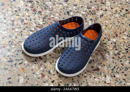 Pair of Blue Shoes Isolated on Mosaic Floor Background