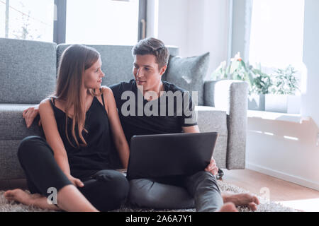 close up. young couple discussing something sitting on the couch . Stock Photo