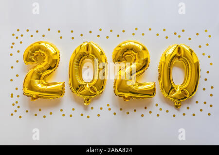 Foil balloons golden color in the form of numbers 2020. New year celebration, christmas, xmas. Flat lay with Air Balloons, top view, mockup, overhead Stock Photo