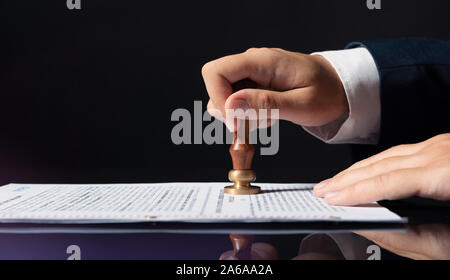 Lawyer, notary, attorney, legal concept. Man stamps the document Stock Photo