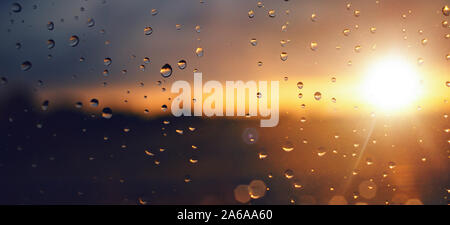 Raindrops on a windowpane at sunset panorama Stock Photo
