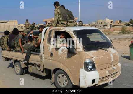 October 21, 2019: Tal Abyad, Syria. 22 October 2019. Fighters of the Syrian National Army opposition group prepare to take over areas withdrawn from Kurdish forces around the Syrian border city of Tal Abyad. The operation is part of a recently military offensive undertaken by the Turkish armed forces with the support of the Turkish-backed Syrian National Army against the Syrian Democratic Forces (SDF) and the People Protection Unit (YPG) on the east of the Euphrates in northern Syria. The ongoing Operation Peace Spring has been launched by Turkey on 9 th October with the stated aim to push the Stock Photo