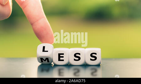Motivation to have less mess. Dice form the expression 'less mess'. Stock Photo