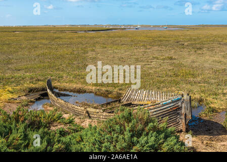 Rustic old boat left to decay on Salt Marshes between Blakeney and Cley next the sea coastal villages on North Norfolk Coast, East of England, UK. Stock Photo