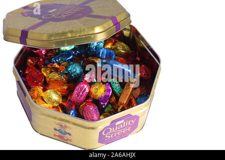 An open tin of Quality Street Christmas Edition 2019 isolated on white background Stock Photo