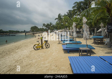 A beautiful sunny day at the beach in Sentosa island a very clean island full of attractions and clean beached with clear water. Stock Photo