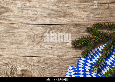 Bavarian napkin with spruce branch on a wooden table with copy space, top view. Food background Stock Photo