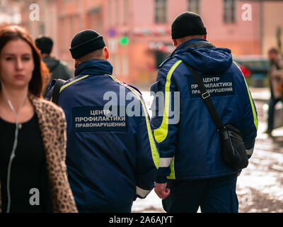 Moscow, Russia - October 19, 2019: Two men in black hats and in uniform with inscriptions on the back 'Center for the Prevention of Crime' patrol is w Stock Photo