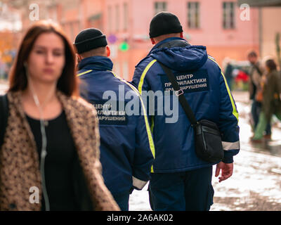 Moscow, Russia - October 19, 2019: Two men in black hats and in uniform with inscriptions on the back 'Center for the Prevention of Crime' patrol is w Stock Photo