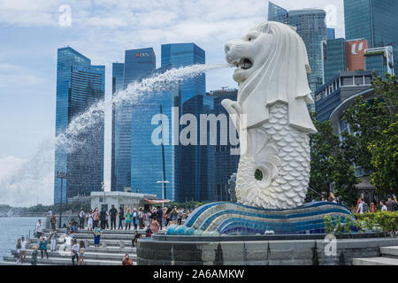 The Merlion statue in a beautiful day around the Marina bay in Singapore , this iconic place will blow your mind with its famous buildings. Stock Photo