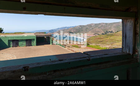 View through an old window in Battery Mendell of Rodeo Beach and the Marin Headlands in California, USA. Stock Photo