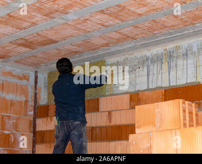 Construction of new brickwork with thermal brick blocks. In the cavity there are rock wool panels for greater thermal and acoustic insulation Stock Photo