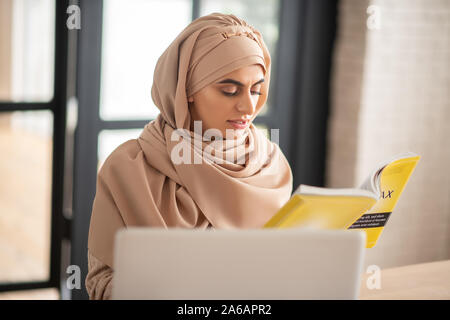 Beautiful woman searching new information in the book Stock Photo